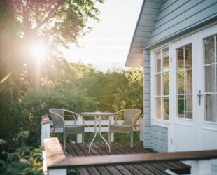 timber deck with trees and sunset in background.