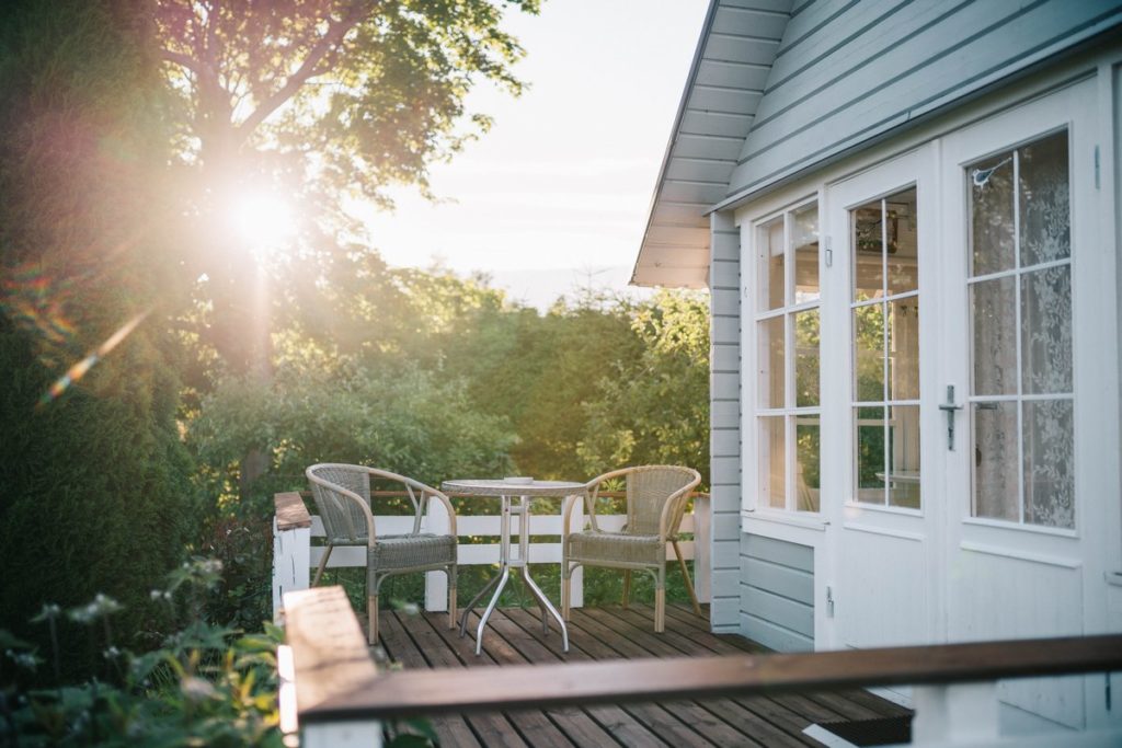 timber deck with trees and sunset in background.
