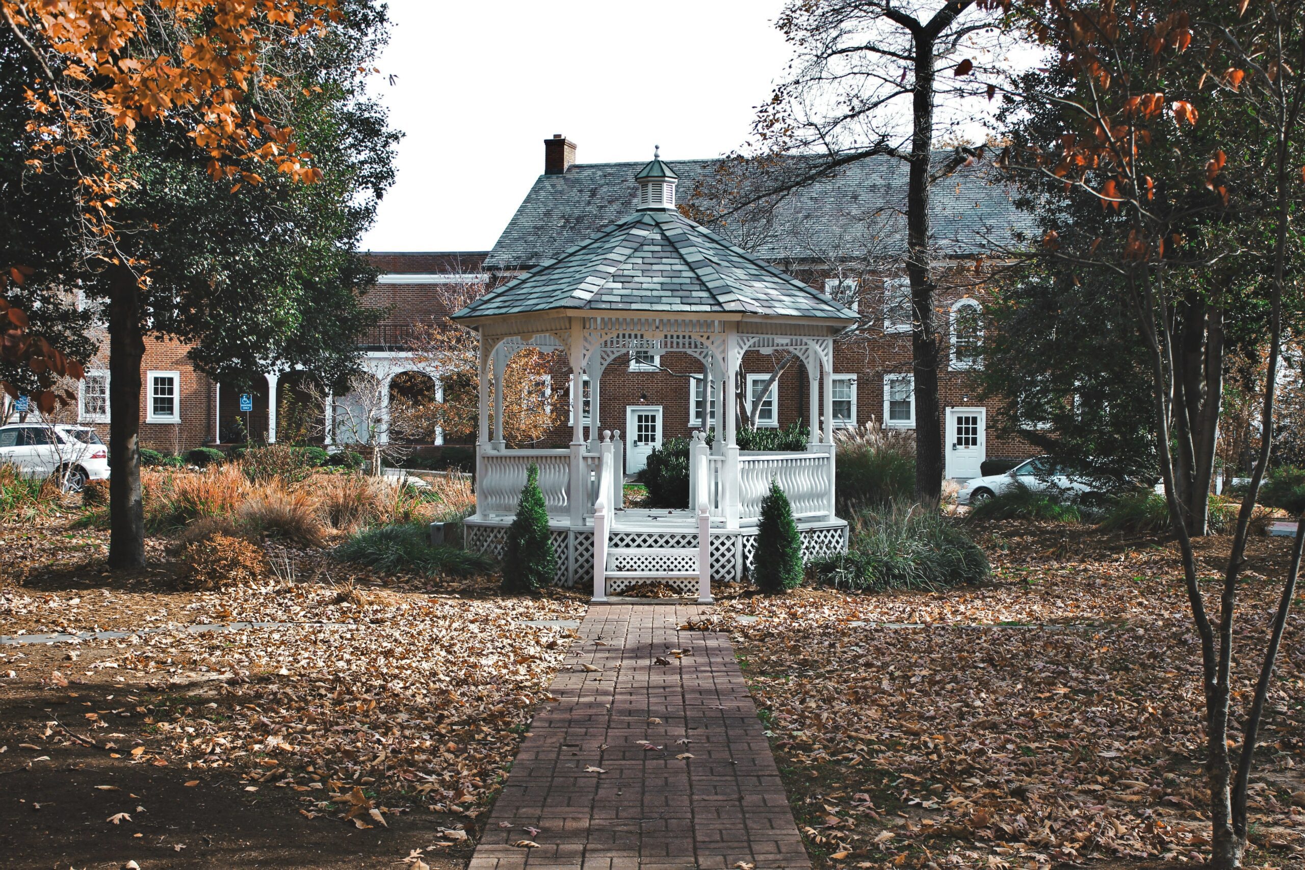 round timber gazebo in front of house