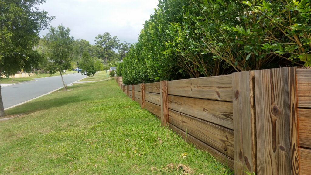timber retaining wall along the nature strip out front of a house