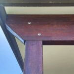structural timber beams secured together on a roof using concealed thread bolts