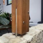 timber post secured to a t-blade post support using concealed thread bolts