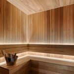 western red cedar shiplap used to clad a sauna. Both the seat and the footrest are covered in the western red cedar shiplap and there is backlighting along the wall