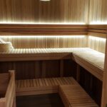 western red cedar shiplap used to clad a sauna. Both the seat and the footrest are covered in the western red cedar shiplap and there is backlighting along the wall