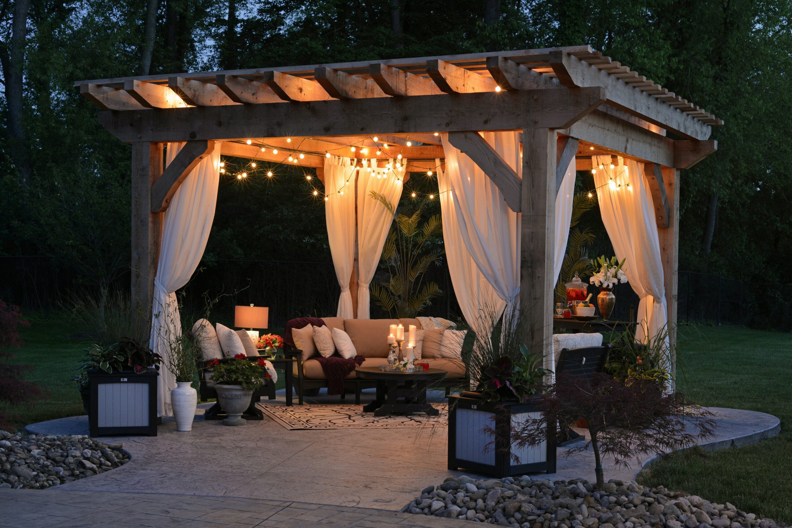 romantic timber pergola lit with candles and fairy lights